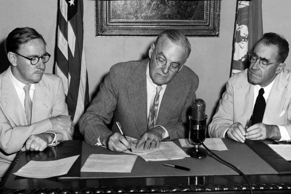 Percy Spender, John Foster Dulles, and Sir Carl Berendsen sign the ANZUS Treaty in San Francisco in 1951 (United States Information Service)